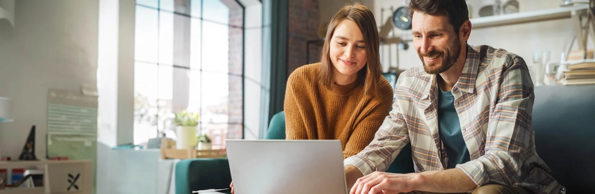 A young couple looking at finances on a computer